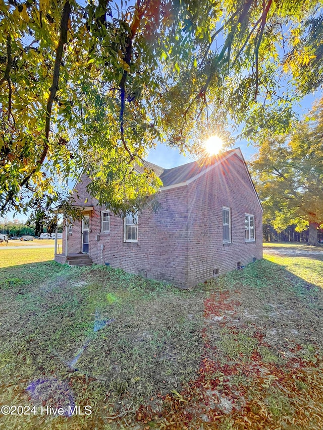 view of property exterior with a yard