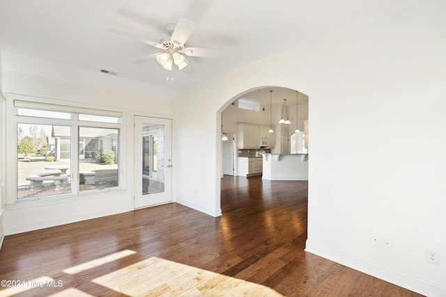 spare room featuring dark hardwood / wood-style flooring and ceiling fan