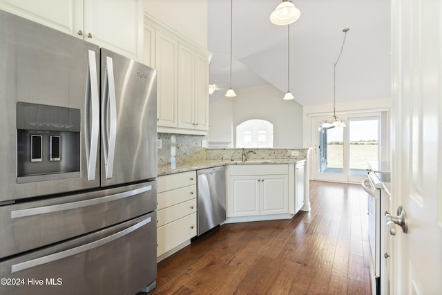 kitchen with white cabinetry, hanging light fixtures, light stone counters, dark hardwood / wood-style flooring, and appliances with stainless steel finishes