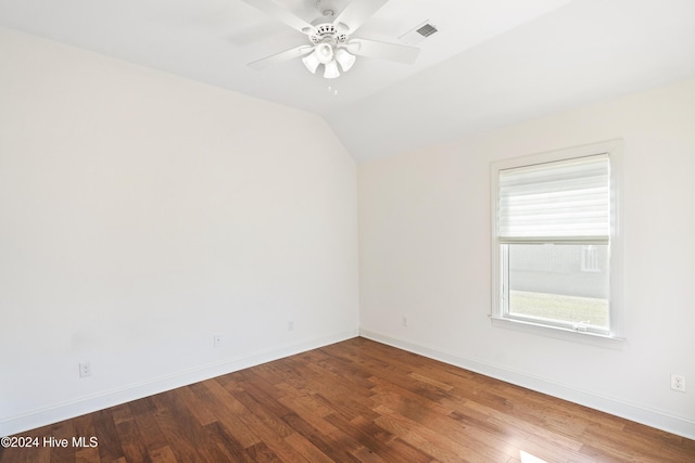 empty room with hardwood / wood-style flooring, ceiling fan, and vaulted ceiling