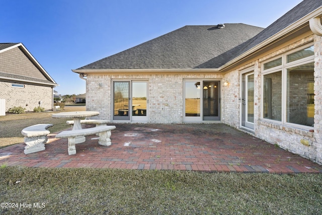 rear view of property featuring a patio area