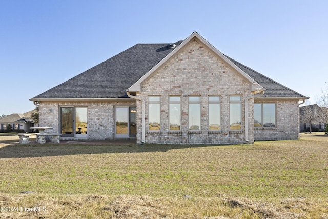 back of house featuring a yard