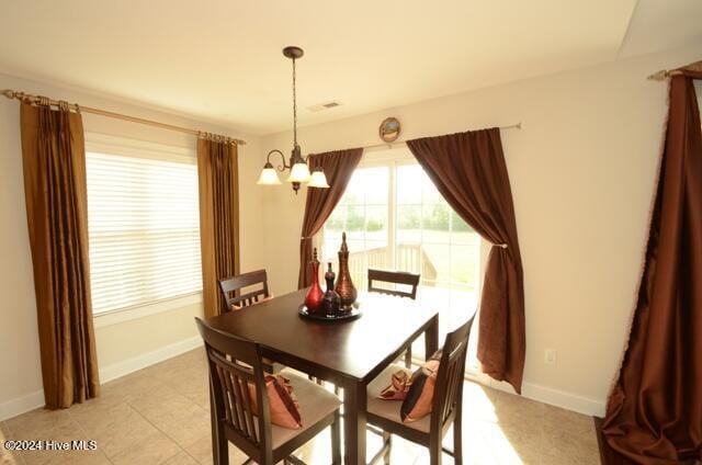 dining space featuring a chandelier