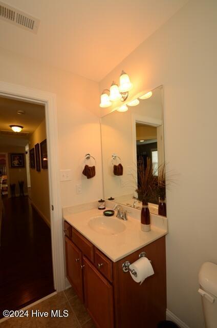 bathroom featuring tile patterned floors, vanity, and toilet