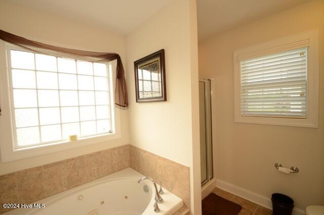 bathroom featuring tile patterned floors, toilet, and independent shower and bath