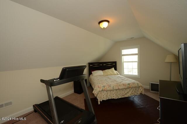 carpeted bedroom featuring vaulted ceiling