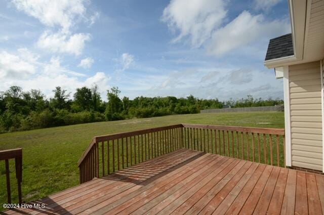 wooden deck featuring a lawn