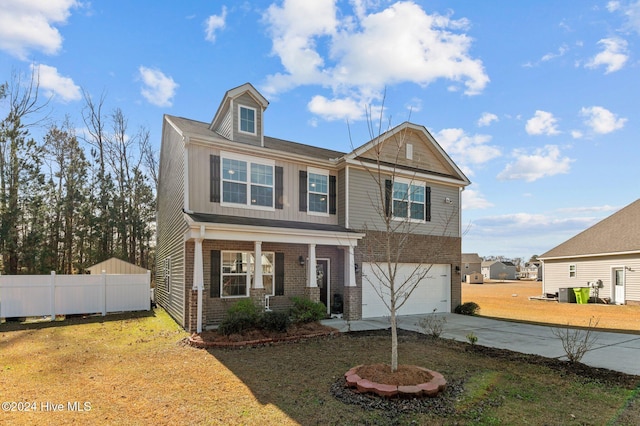 view of front of house featuring a garage and a front lawn