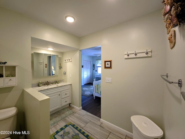 bathroom featuring vanity and toilet