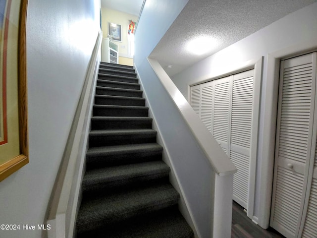 stairway featuring hardwood / wood-style flooring