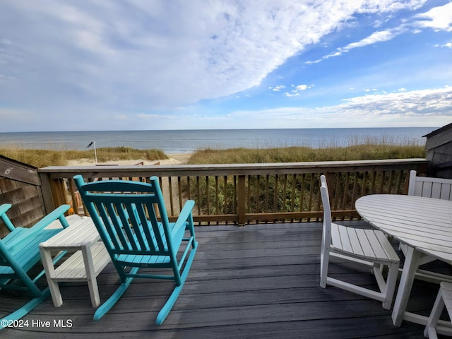 wooden terrace featuring a water view