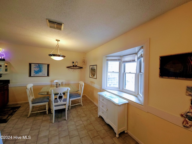 dining area with a textured ceiling