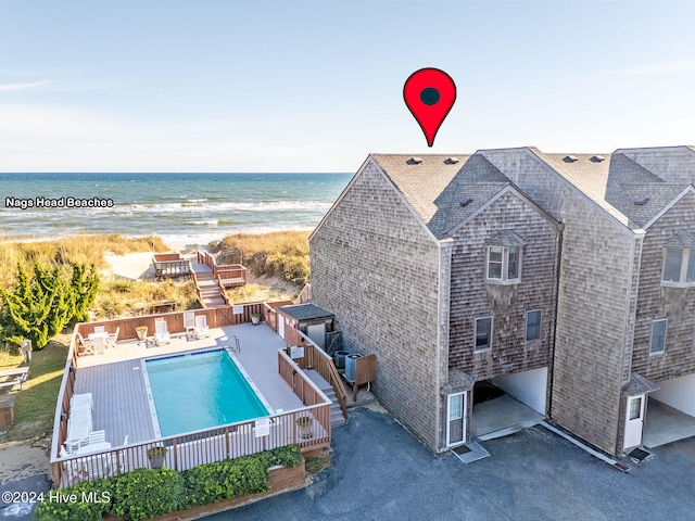 exterior space with a beach view and a water view