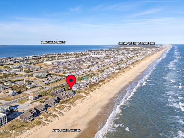 birds eye view of property featuring a water view and a beach view