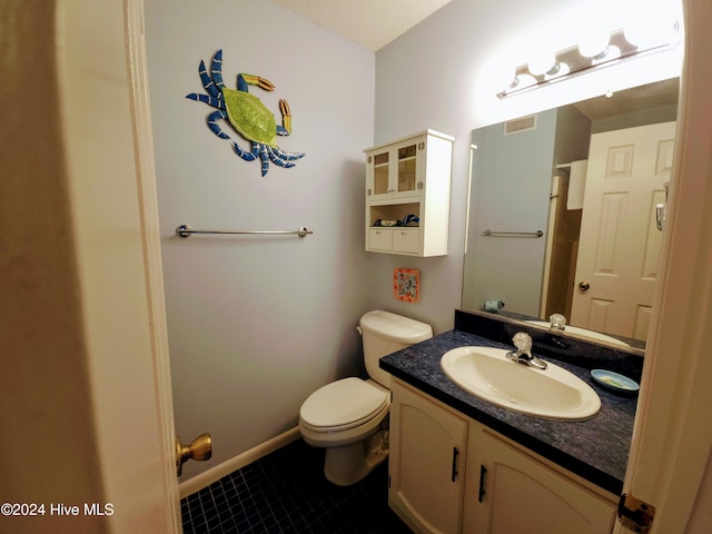 bathroom featuring tile patterned floors, vanity, and toilet