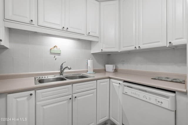 kitchen featuring dishwasher, white cabinetry, sink, and tasteful backsplash