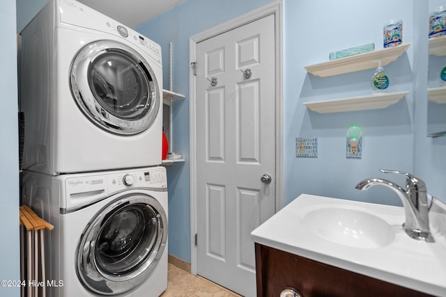 laundry room with stacked washer / drying machine, light tile patterned floors, and sink