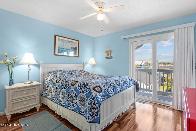 bedroom featuring access to exterior, ceiling fan, wood-type flooring, and a textured ceiling