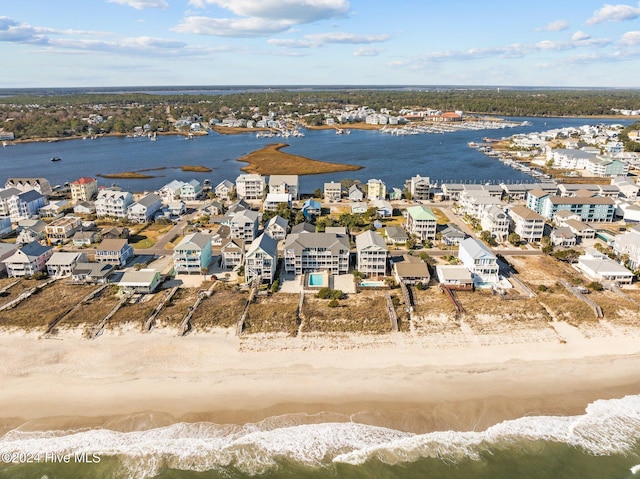 bird's eye view featuring a water view and a view of the beach