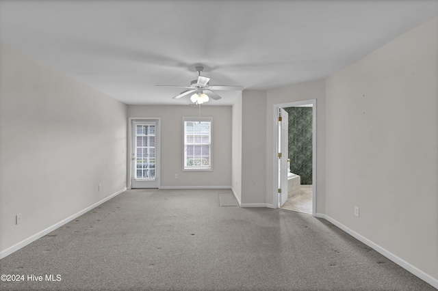 carpeted empty room featuring ceiling fan