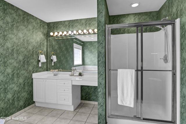 bathroom with tile patterned flooring, vanity, and a shower with shower door