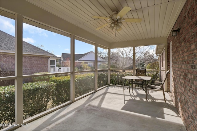 unfurnished sunroom with ceiling fan and wood ceiling