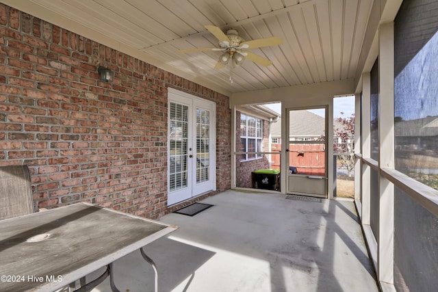 unfurnished sunroom with french doors, ceiling fan, and wood ceiling