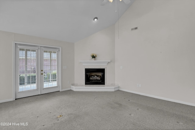 unfurnished living room featuring carpet flooring, ceiling fan, high vaulted ceiling, and french doors