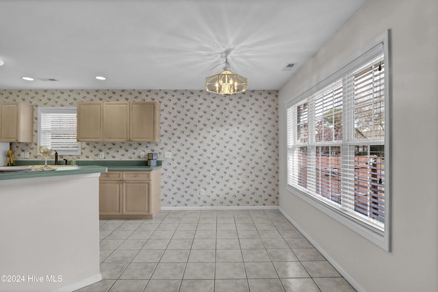 kitchen with sink, a notable chandelier, decorative light fixtures, light brown cabinetry, and light tile patterned floors