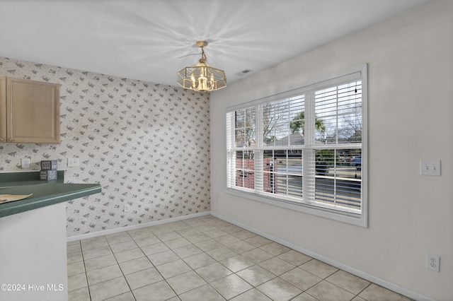 unfurnished dining area featuring a chandelier