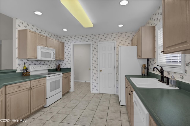 kitchen with light brown cabinetry, white appliances, light tile patterned floors, and sink