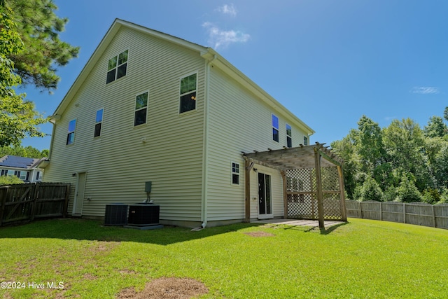 back of house featuring a lawn and a pergola