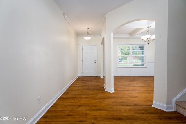 hallway featuring beamed ceiling, a notable chandelier, dark hardwood / wood-style flooring, and ornamental molding