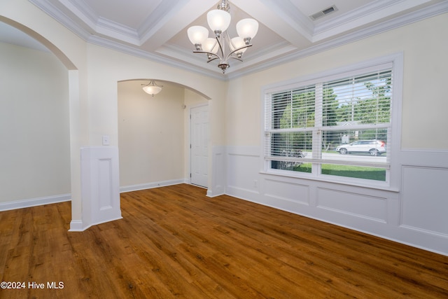 unfurnished room featuring beamed ceiling, hardwood / wood-style flooring, an inviting chandelier, and ornamental molding