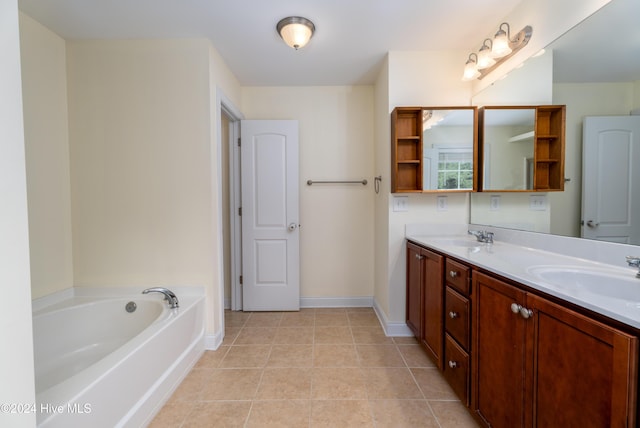 bathroom with tile patterned flooring, vanity, and a washtub