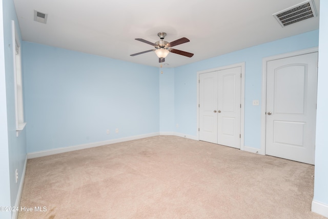 unfurnished bedroom with light carpet and ceiling fan