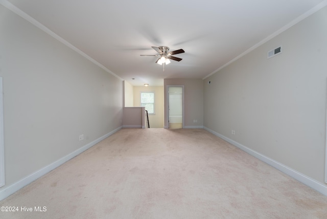 empty room with crown molding, ceiling fan, and light colored carpet