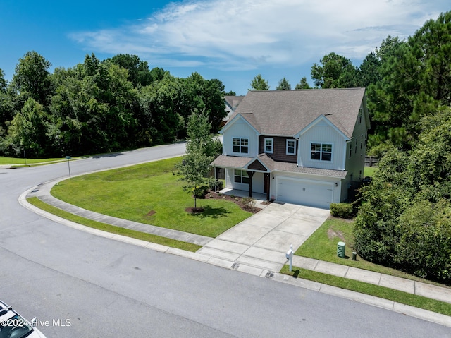 view of front of property featuring a garage and a front lawn