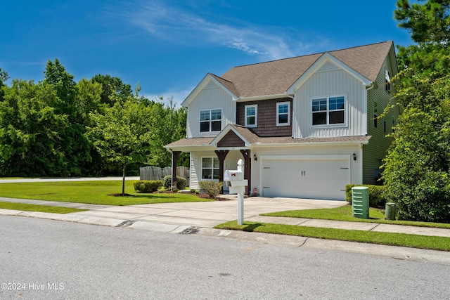 view of front of home with a garage and a front lawn