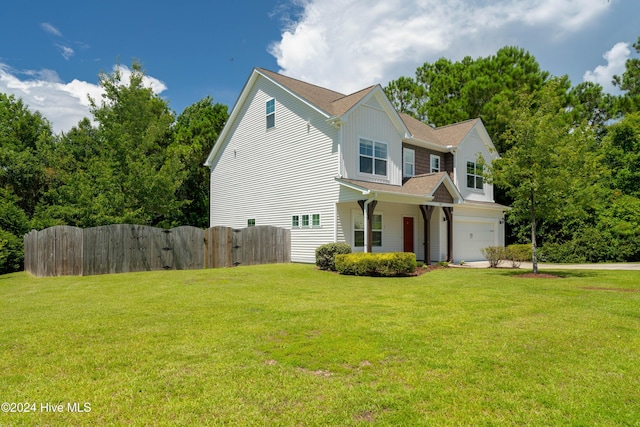 view of front facade with a front yard and a garage