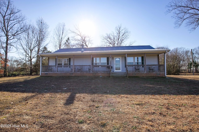 ranch-style house with a porch and a front lawn