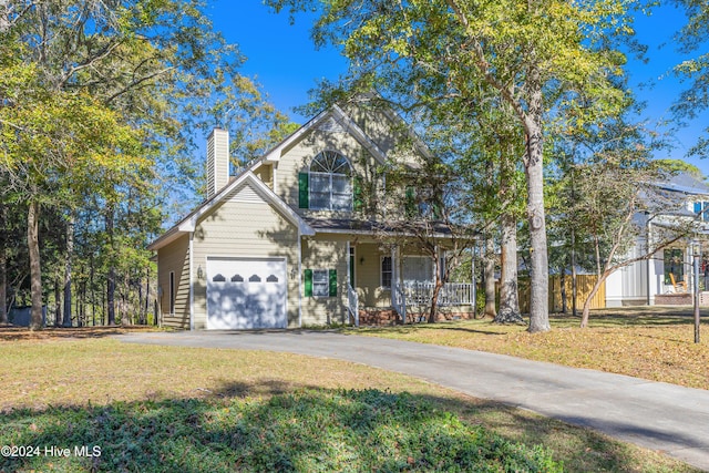 view of front facade with a front yard, a porch, and a garage