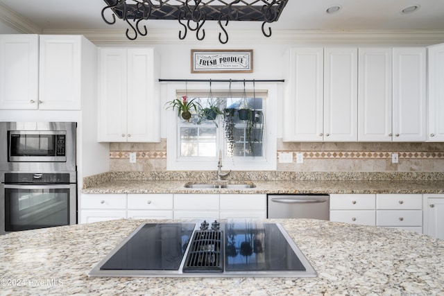 kitchen with crown molding, sink, white cabinets, and appliances with stainless steel finishes