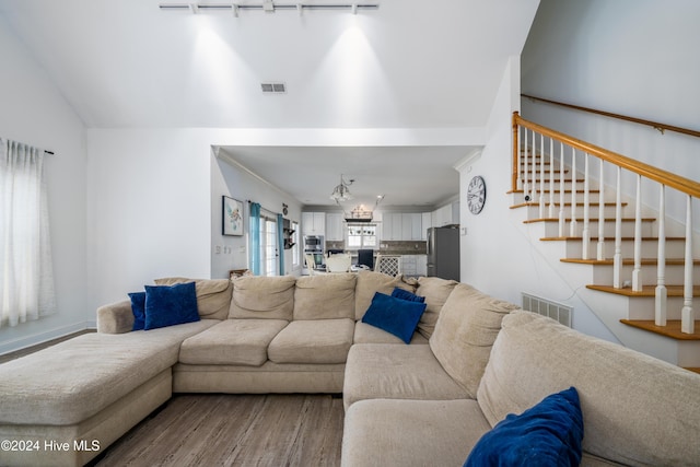 living room featuring rail lighting and hardwood / wood-style flooring