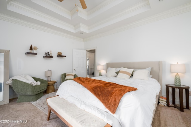 carpeted bedroom with a tray ceiling, ceiling fan, and ornamental molding