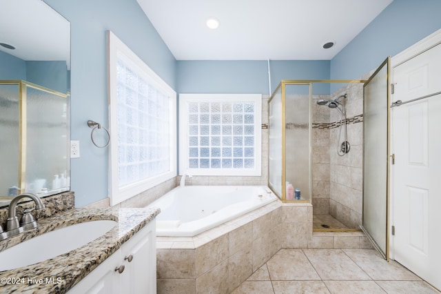 bathroom with tile patterned flooring, vanity, and independent shower and bath