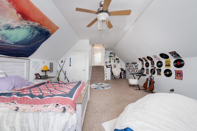 carpeted bedroom with ceiling fan and vaulted ceiling