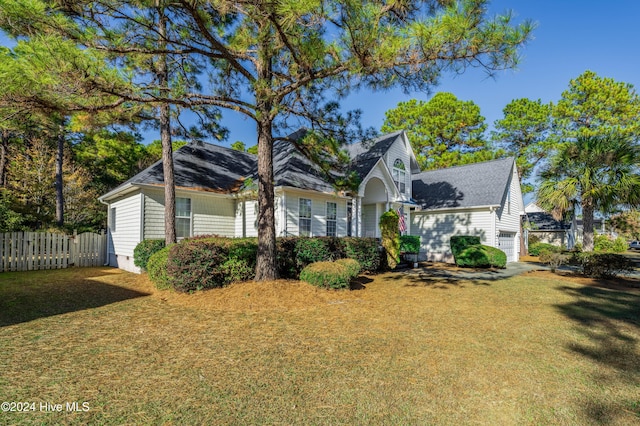 view of front of property with a front lawn and a garage