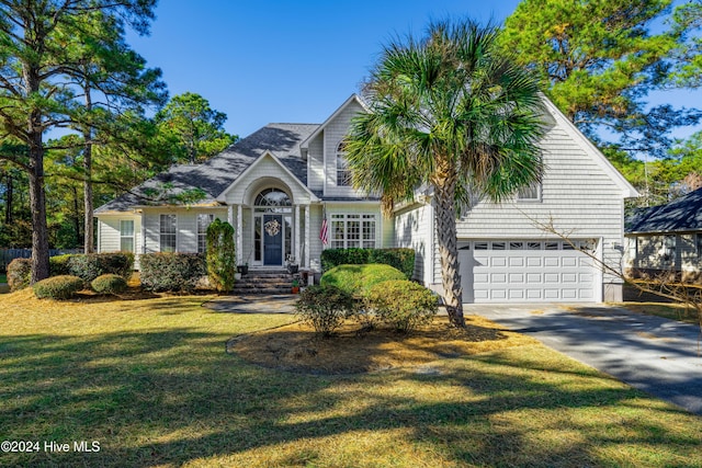 view of front of home featuring a front lawn and a garage