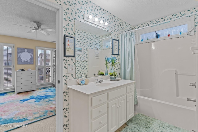 bathroom featuring vanity, shower / bath combination with curtain, a textured ceiling, and ceiling fan